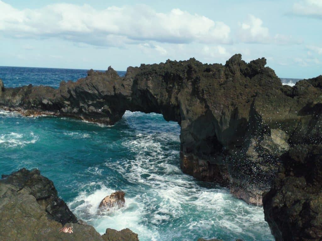 Sea arch with a crabby admirer